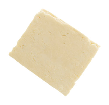 Top view of a block of Feta cheese on a white background.