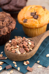 Homemade muffins with chocolate, vintage background.
