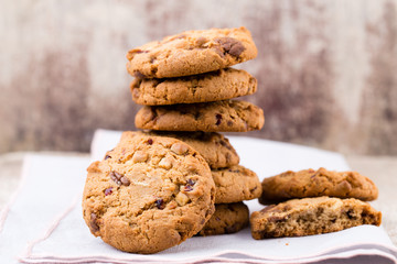 Chocolate oatmeal cookies on the wooden background.