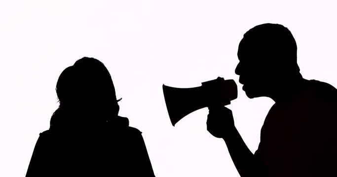 Silhouette of young man scolding a woman using a megaphone in the studio, isolated on white background. Shot in 4k resolution