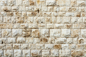 Fragment of a wall made of limestone bricks