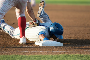baseball player hitting and sliding