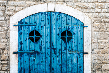 Old and obsolete blue wooden doors