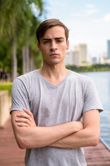 Fototapeta premium Young handsome man relaxing at the park