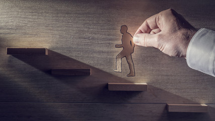 Retro toned image of a business man climbing steps towards the light