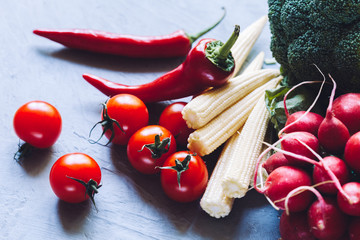 Fresh vegetables on grey background, closeup. Healthy rustic food.