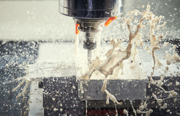 Milling metalworking process. Industrial CNC metal machining by vertical mill. Coolant and...