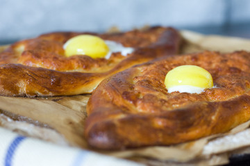 Two Georgian khachapuri in Adjarian close-up. Fresh traditional pastries.