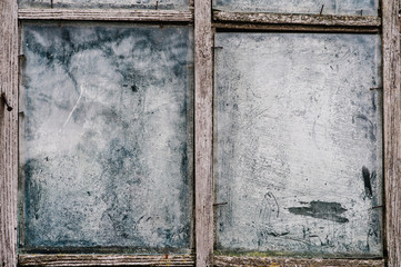 Old wooden window with dirty glass