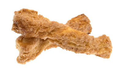 Two crunchy baked twisted cookies isolated on a white background.