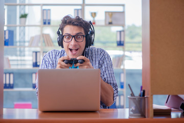 Gamer addict playing computer games at home