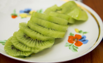 Fresh sliced kiwi fruit on the white plate