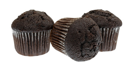 Side view of three bite size chocolate muffins with one on its side isolated on a white background.