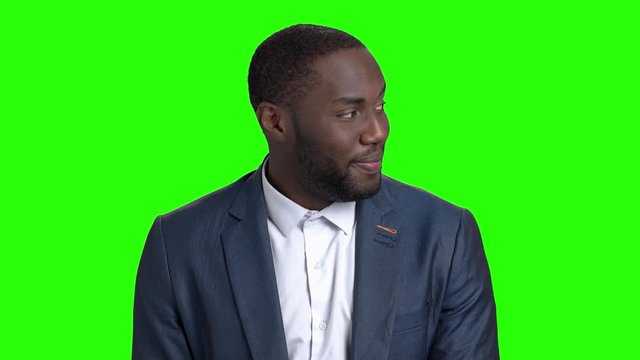 Macho-man looking at a girl passing by. Flirtatious afro-american man in business suit on chroma key background.