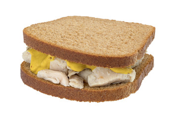 Chicken breast sandwich on wheat bread and mustard isolated on a white background.