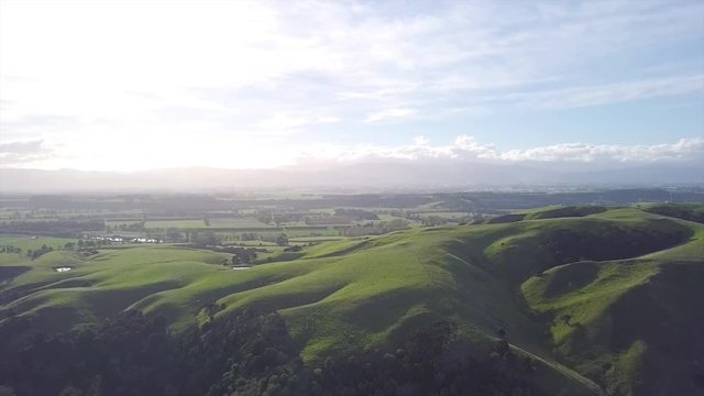 Aerial, gorgeous landscape of new zealands martinborough hills at sunset.