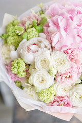Floristry concept. Bouquet of beautiful flowers on gray table. Spring colors. the work of the florist at a flower shop.
