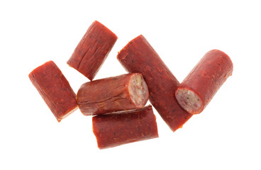 Bite size beef sausages on a white background