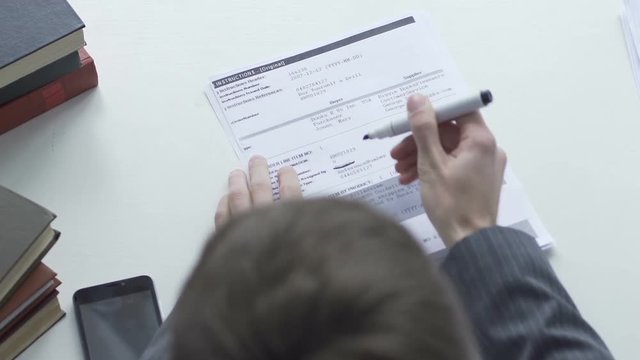 Man doing paperwork, crossing out information, lawyer checking contract for sale