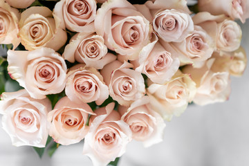 pastel pink roses. Bouquet of beautiful flowers on wooden table. Floristry concept. the work of the florist at a flower shop. Vertical photo