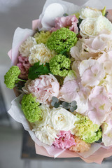 Floristry concept. Bouquet of beautiful flowers on gray table. Spring colors. the work of the florist at a flower shop.