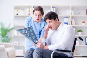 Fototapeta premium Doctor discussing x-ray image with patient