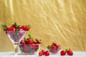 Fresh strawberries in a bowl on a white background.