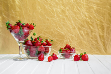 Fresh strawberries in a bowl on a white background.