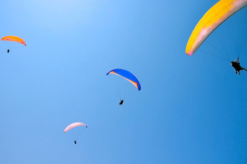 paroplane group flying against the blue sky..Above the Mediterranean Sea, Israel..Extreme sports, enjoy life, appreciate the time,.tandem paragliding, controlled pilot