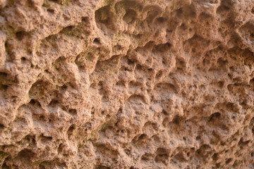 Abstract relief porous sand stone brown beige surface, background, texture.   .