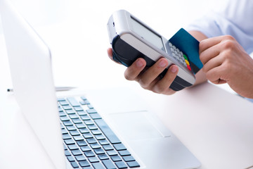 Man processing credit card transaction with POS terminal