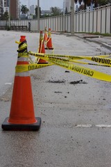 orange traffic cones and bilingual yellow caution tape