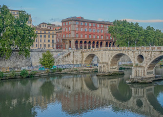 Fototapeta premium Rome, Lazio, Italy - September 12, 2017: View of Ponte Sisto with reflections on the Tiber river at a sunset in Rome