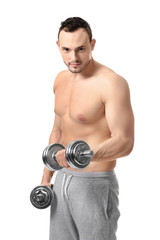 Fototapeta na wymiar Muscular young bodybuilder with dumb-bells on white background