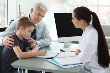 Fototapeta premium Senior man with his grandson having appointment at child psychologist office