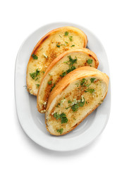 Plate with delicious homemade garlic bread isolated on white