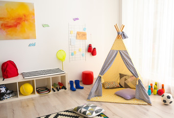 Modern room interior with play tent for child © New Africa