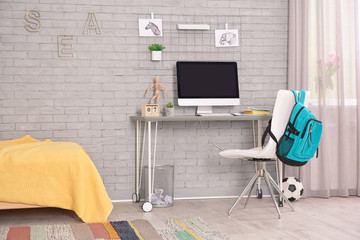 Comfortable workplace with modern computer in child room