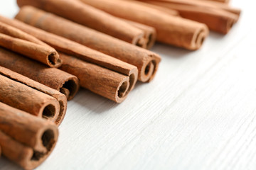 Aromatic cinnamon sticks on wooden background