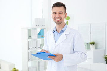 Young male receptionist working in hospital