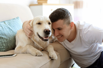 Portrait of owner with his friendly dog at home