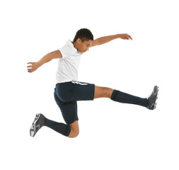 Teenage African-American boy playing football on white background
