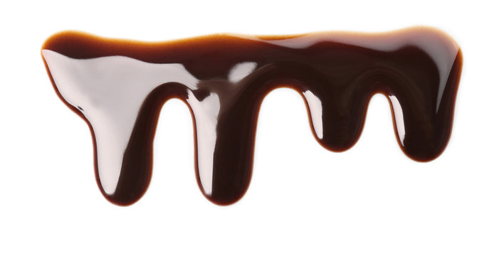 Flowing chocolate sauce on white background
