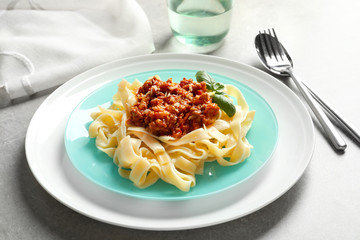 Plate with delicious pasta bolognese on table