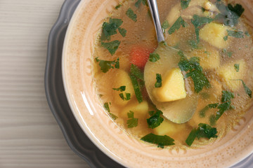 Bowl with delicious hot broth on table, top view. Cold treatment