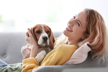 Young woman with her dog at home