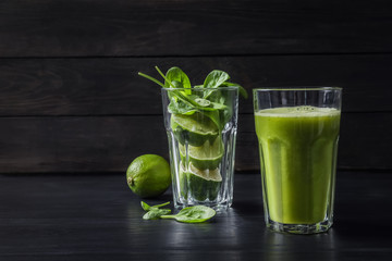 Glasses with delicious detox juice and ingredients on table