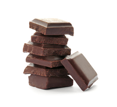 Delicious black chocolate pieces on white background