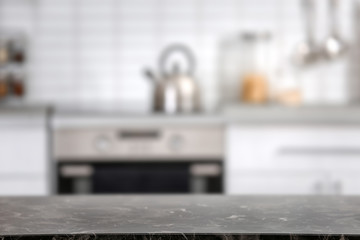 Fototapeta na wymiar Countertop and blurred view of kitchen interior. Idea for home design