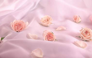Composition with beautiful roses on color fabric